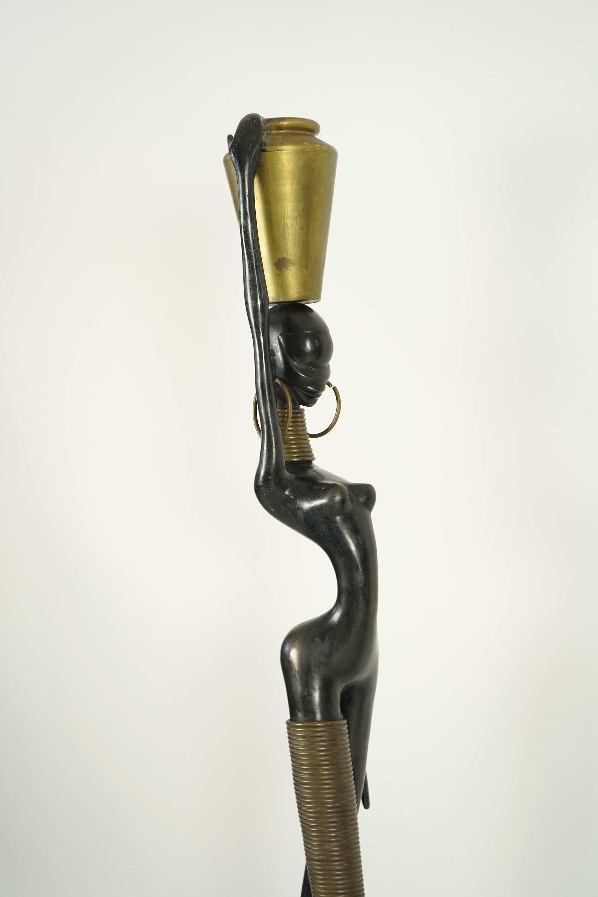 A large pair of Hagenauer style ebonised bronze 'Giraffe Woman' figures